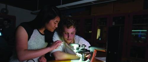 Students working with science lab equipment